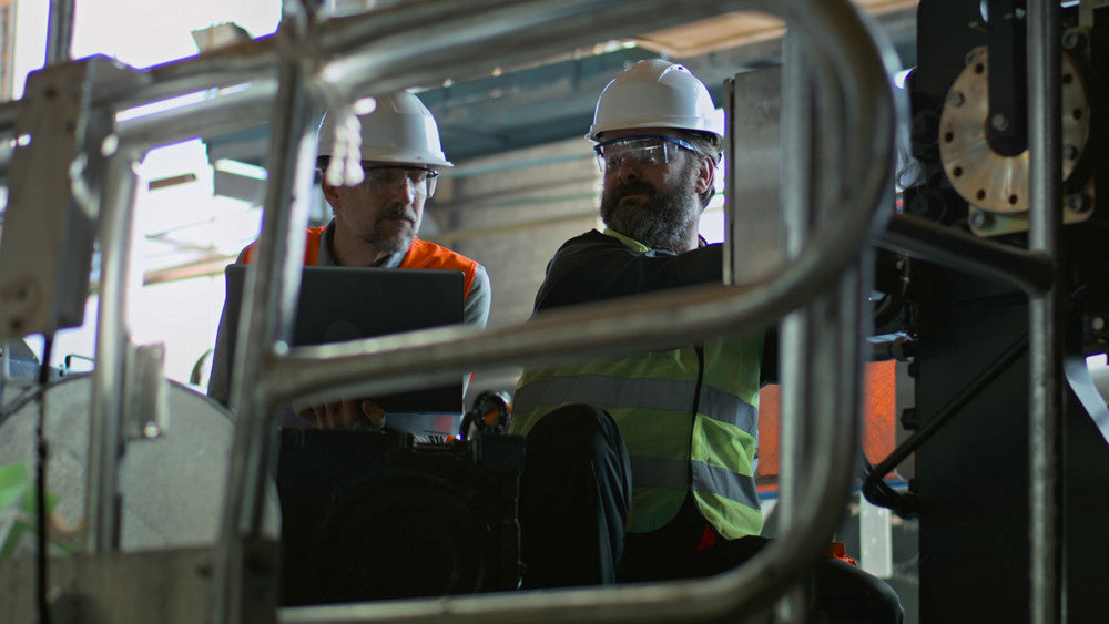 Workers in hard hats on a job site, highlighting a trusted safety equipment supplier