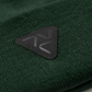 Close-up of Vohl Beanie in Deep Forest Green showing black triangular logo patch and knit texture - SKU AC-BN-400-OS | color:Deep Forest Green