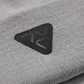 Close-up of Vohl Beanie in Pewter showing black triangular logo patch and knit texture - SKU AC-BN-700-OS | color:Pewter