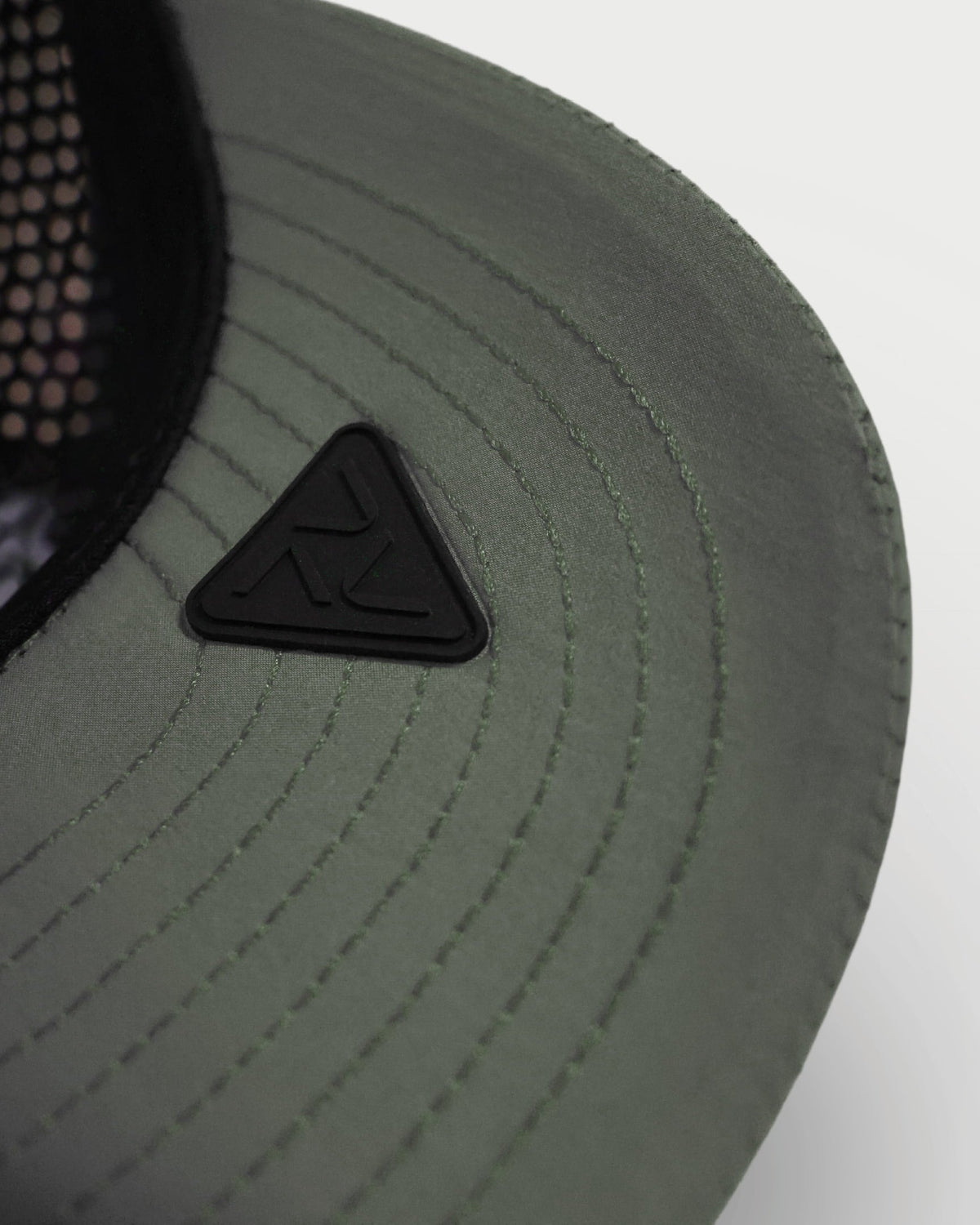 Close-up of the green Vohl Cap underside brim with stitched detailing and black Vohl logo patch - SKU AC-CV-400-OS | color:Green