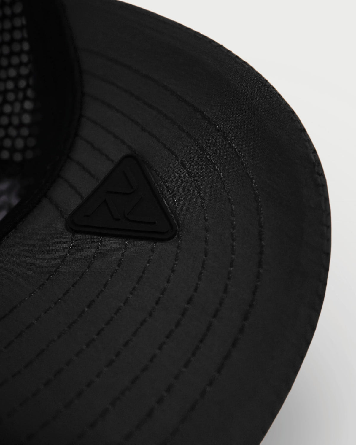 Close-up of the black Vohl Cap underside brim with stitched detailing and tonal Vohl logo patch - SKU AC-CV-900-OS | color:Black