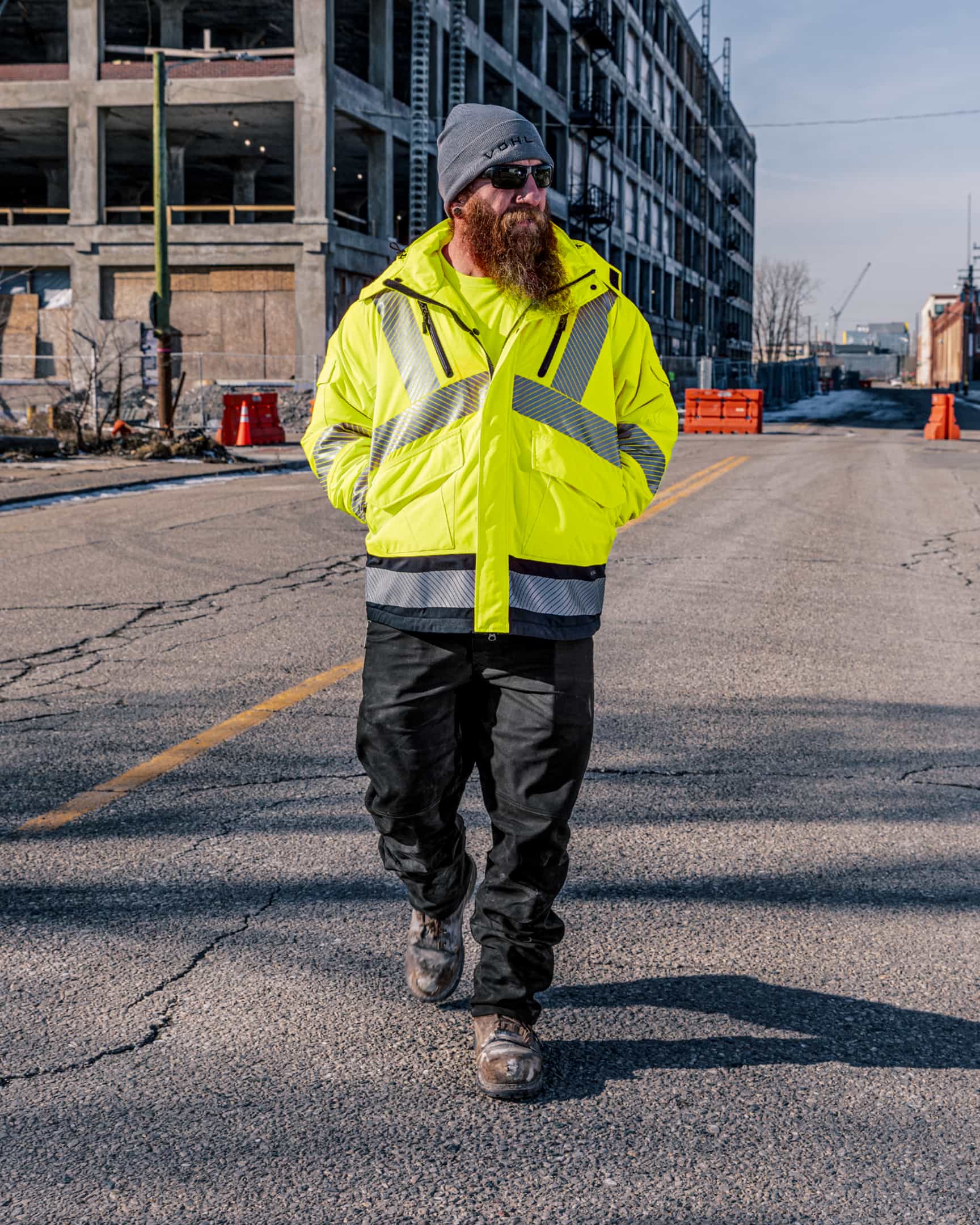 Men’s hi-vis yellow insulated waterproof jacket with reflective tape, worn on a construction site – SKU HV-IJ-105 | color:Safety Yellow