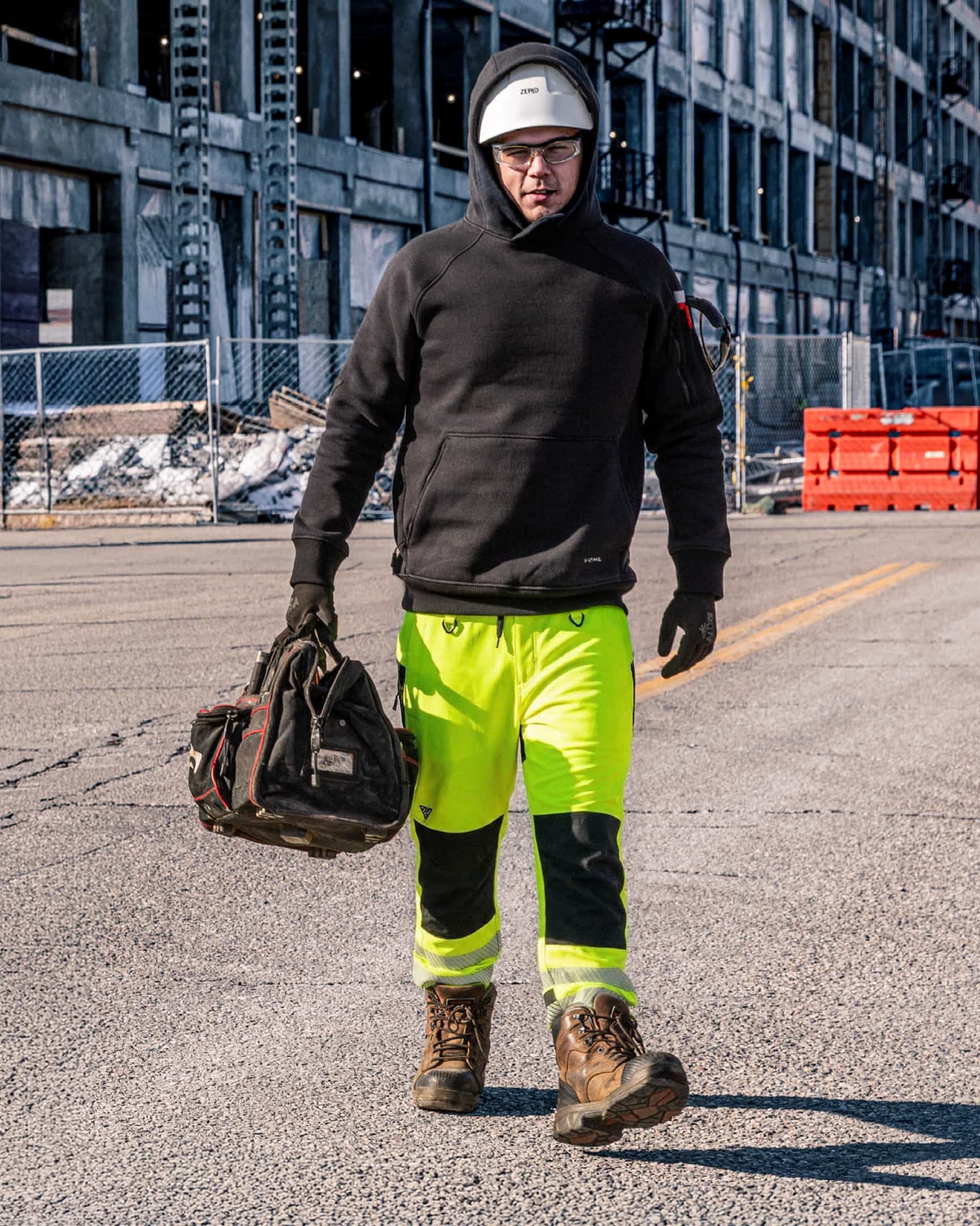 Men’s hi-vis yellow waterproof shell work pants with reflective tape and reinforced knees, worn on construction site – SKU HV-SP-105 | color:Safety Yellow