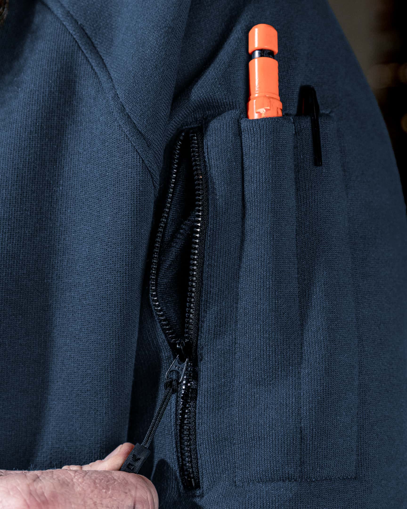 Close-up of blue heavyweight fleece hoody sleeve pocket with zipper and pen slot – SKU WW-PO-600 | color:Detroit Blue