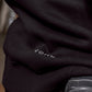 Close-up of Black heavyweight fleece hoody hem with Vohl logo detail – SKU WW-PO-900 | color:Black