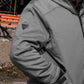 Close-up of Pewter quilted lined work jacket sleeve with logo detail and pocket – SKU WW-UJ-700 | color:Pewter